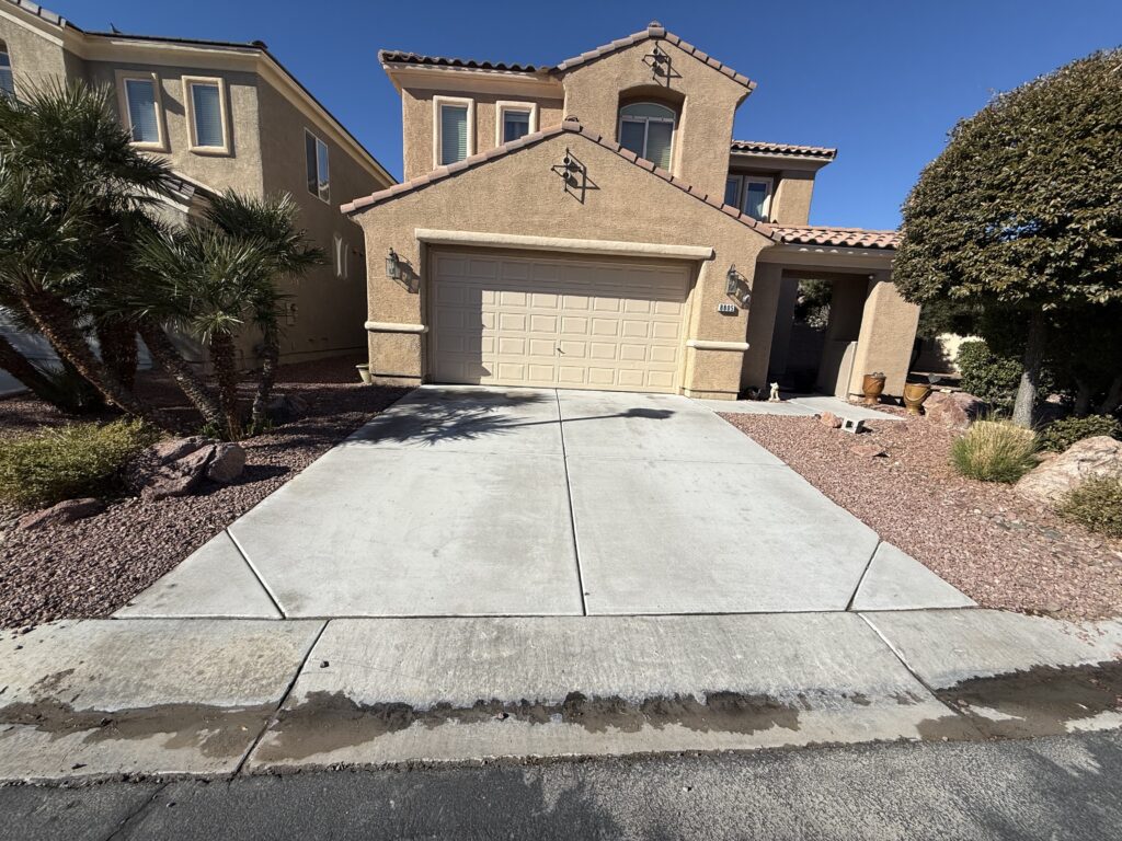 Commercial pressure washing in Las Vegas cleaning a storefront and parking lot, removing grease, gum, and heavy traffic buildup for a clean professional appearance